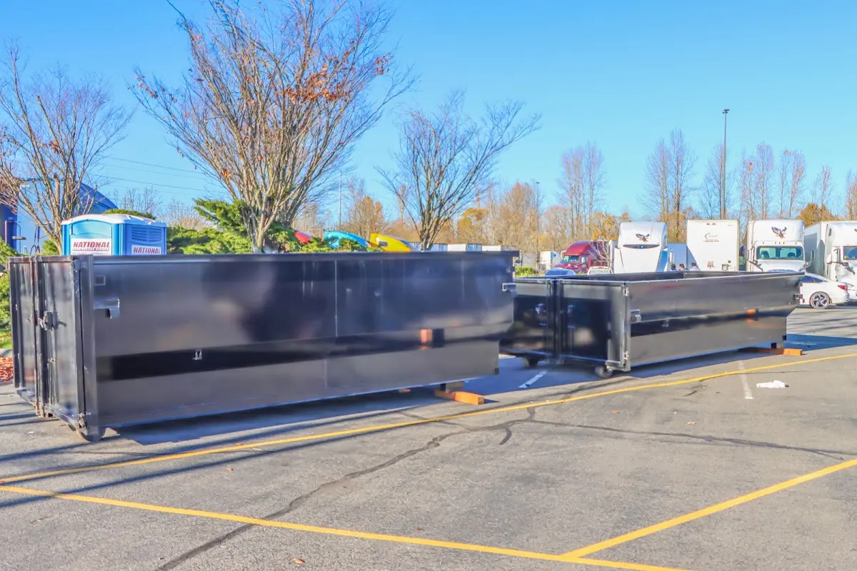 Professional dumpster rental service with roll-off container on residential driveway in Sunrise